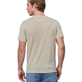 Back of a man wearing a Patagonia men's Capilene Cool merino blend shirt in a cream colour.