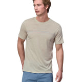 Man wearing a Patagonia men's Capilene Cool merino blend shirt in a cream colour.