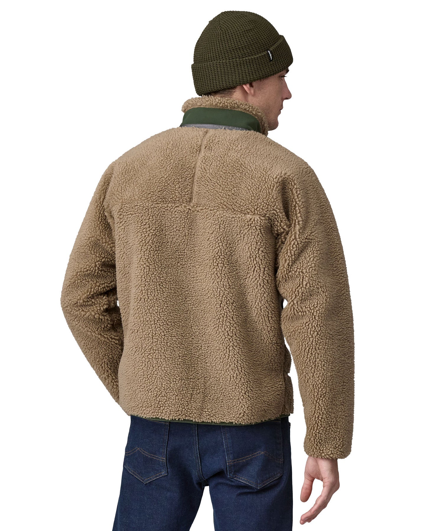 A man wearing a Patagonia Men's Classic Retro-X Jacket in a Seabird Grey colour and a green beanie hat facing away from the camera showing the back of the jacket. 