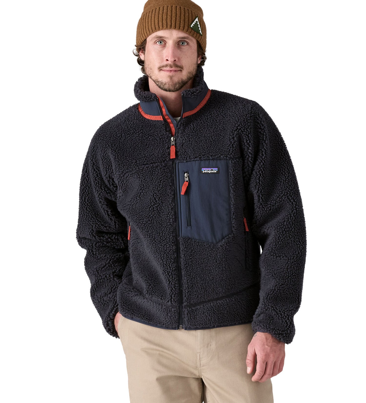 A man wearing a Patagonia Men's Classic Retro-X Jacket in a dark smolder blue colour.  