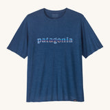 Patagonia Men's Capilene Cool Daily Graphic Shirt is a warm blue coloured top with short sleeves and the brand name printed across the chest. 