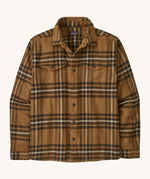 Patagonia men's fjord shirt. A long sleeve buttoned flannel style shirt in different shades of brown, features 2 chest pockets and a logo patch stitched on the inside.
