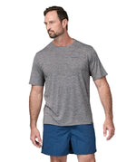 A man wearing a Patagonia Men's Capilene Cool Daily Graphic Shirt with a Waters / Feather Grey design, showing the front of the t-shirt. 
