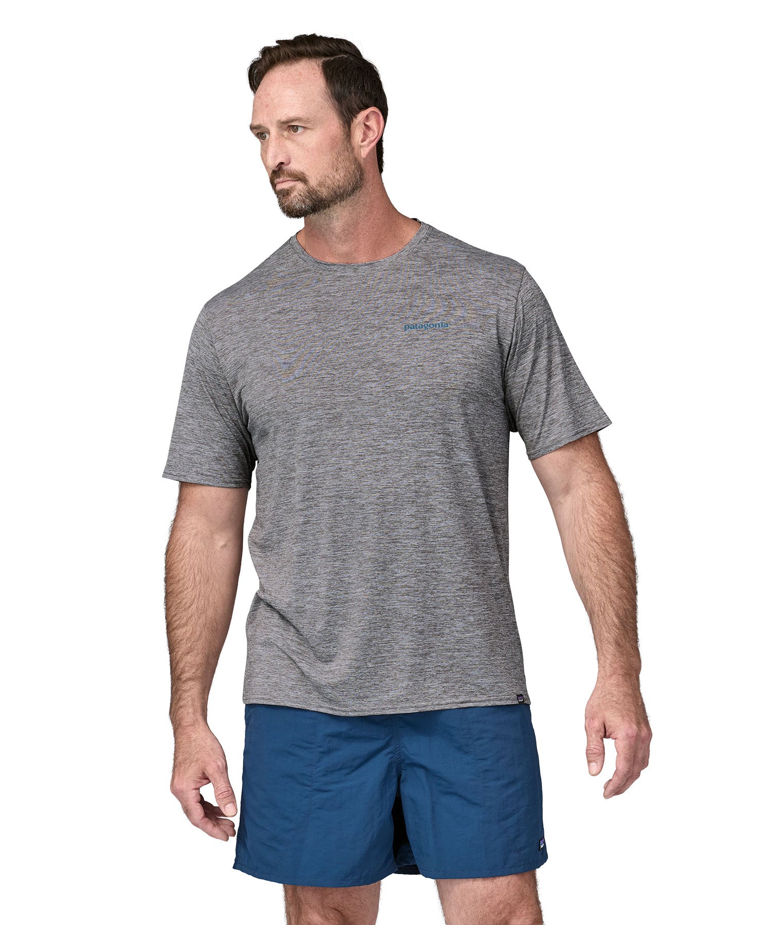 A man wearing a Patagonia Men's Capilene Cool Daily Graphic Shirt with a Waters / Feather Grey design, showing the front of the t-shirt. 