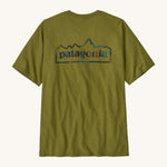 Patagonia men's unity fitz short sleeve top in a green colour on a cream background.