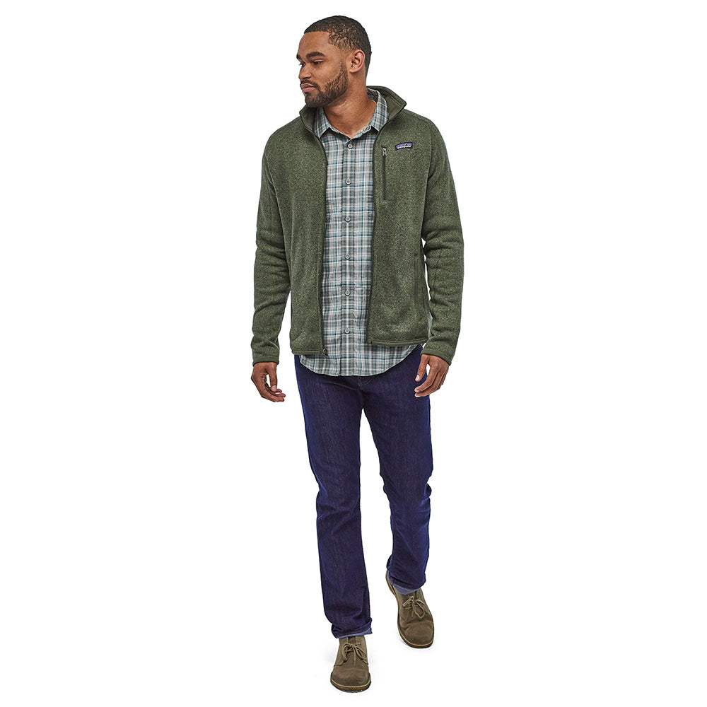 Man stood on a white background wearing the Patagonia thermal fleece Better Sweater Jacket in the Industrial Green colour