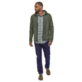 Man stood on a white background wearing the Patagonia thermal fleece Better Sweater Jacket in the Industrial Green colour