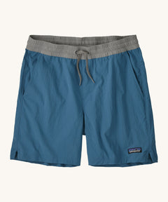 patagonia mens baggies shorts in a dark blue colour on a cream background.