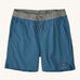 patagonia mens baggies shorts in a dark blue colour on a cream background.