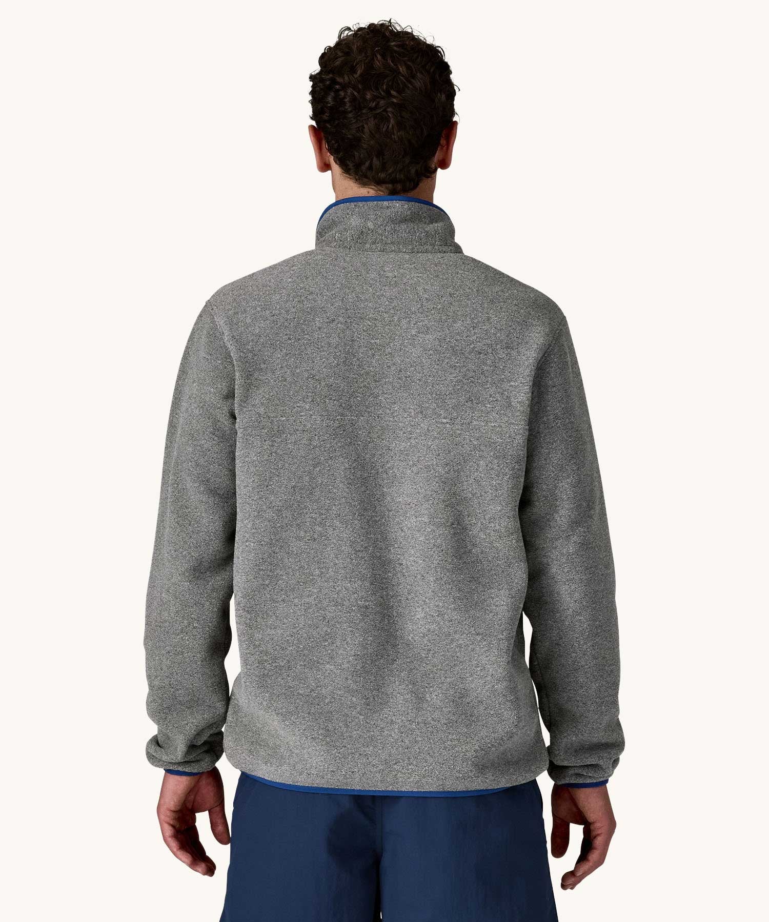 The back of a man wearing the Patagonia Men's Lightweight Synchilla® Snap-T Fleece Pullover in a grey colourway.