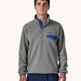A man wearing the Patagonia Men's Lightweight Synchilla® Snap-T Fleece Pullover in a grey colourway.