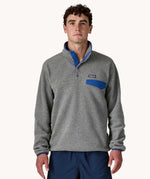 A man wearing the Patagonia Men's Lightweight Synchilla® Snap-T Fleece Pullover in a grey colourway.