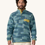 A man wearing the Patagonia Men's Lightweight Synchilla Snap-T Fleece in Quilty Fitz / Wetland Blue.