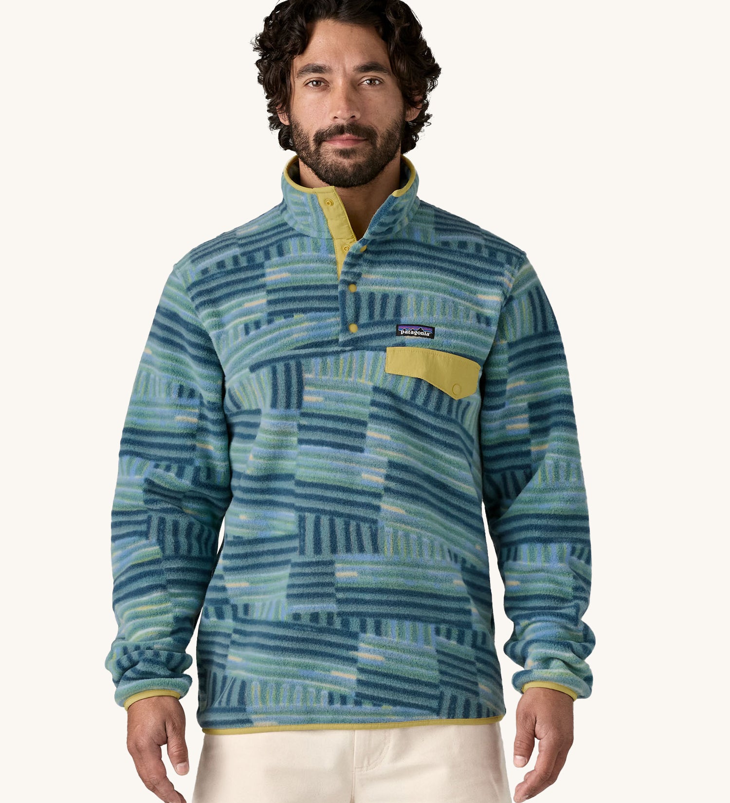 A man wearing the Patagonia Men's Lightweight Synchilla Snap-T Fleece in Quilty Fitz / Wetland Blue.