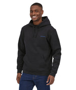 Patagonia men's uprisal hoodie in ink black worn by a man