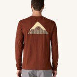 A view of the back of a man wearing a brown coloured Patagonia Men's Long Sleeved Organic T-Shirt with Driftways design. This t-shirt is a part of a wide range of Patagonia clothing and accessories available here at Babipur. 
