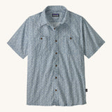 Patagonia Back Step Shirt, made with a blend of 55% industrial hemp and 45% organic cotton. In light blue with an understated Mountain Breeze print, it features short sleeves, coconut buttons, and two chest pockets. 