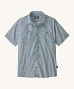 Patagonia Back Step Shirt, made with a blend of 55% industrial hemp and 45% organic cotton. In light blue with an understated Mountain Breeze print, it features short sleeves, coconut buttons, and two chest pockets. 