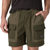 Close up of Patagonia Men's Outdoor Everyday Shorts in Pine Needle Green being worn. The man has a hand in one of the pockets.