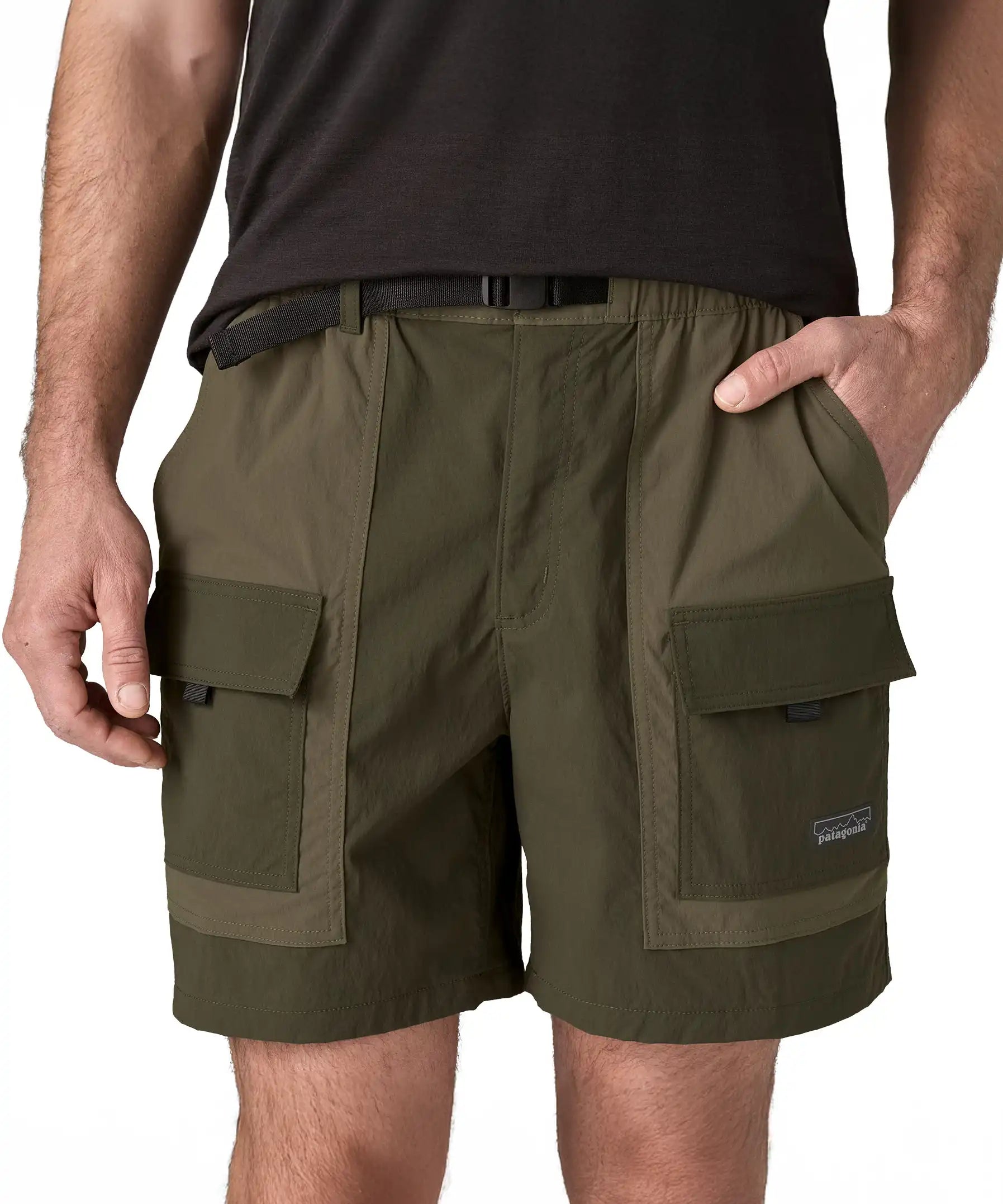 Close up of Patagonia Men's Outdoor Everyday Shorts in Pine Needle Green being worn. The man has a hand in one of the pockets.