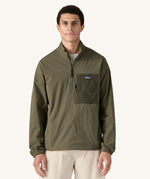 A man wearing the Patagonia Men's Outdoor Everyday Marsupial Pullover in Basin Green.