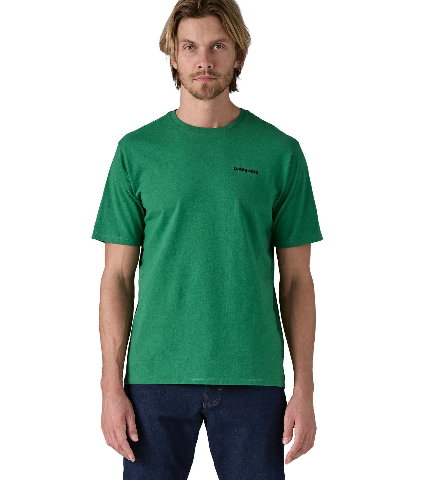 Patagonia men's short sleeve top in green logo outline design worn by a man front detail