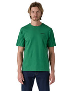 Patagonia men's short sleeve top in green logo outline design worn by a man front detail