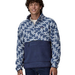 A man wearing a Patagonia Men's Retro Pile 1/2 Snap Pull Over in a New Navy design stood in front of a plain background. 