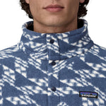 A close up of a person's neck wearing a Patagonia Men's Retro Pile 1/2 Snap Pull Over in a New Navy design. The front poppers are all closed right to the top of the collar. 