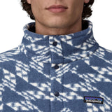 A close up of a person's neck wearing a Patagonia Men's Retro Pile 1/2 Snap Pull Over in a New Navy design. The front poppers are all closed right to the top of the collar. 
