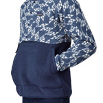 A close up of a person wearing a Patagonia Men's Retro Pile 1/2 Snap Pull Over in a New Navy design.  The person's hand are in the front kangaroo style pocket. 