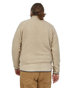 The view of a man's back wearing a Patagonia Men's Retro Pile Jkt in a cream colour