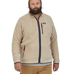 A man wearing the Patagonia Men's Retro Pile Jkt in a cream colour