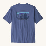 Patagonia Men's 73 Skyline Organic T-Shirt. A pale blue coloured top with short sleeves and a  brand logo in a sketch design printed on the back