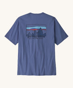 Patagonia Men's 73 Skyline Organic T-Shirt. A pale blue coloured top with short sleeves and a  brand logo in a sketch design printed on the back