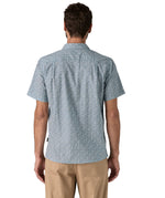 Back of man wearing the Patagonia Back Step Shirt, made with a blend of 55% industrial hemp and 45% organic cotton. In light blue with an understated Mountain Breeze print, it features short sleeves, and a subtle drop tail hem.  