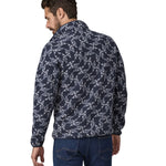 A man wearing a Patagonia Men's Synch Snap-T Pull Over in New Navy showing the back of the jacket