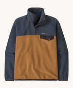Patagonia mens synchilla jacket. A lightweight fleece in dark blue and brown colour. Features a chest pocket, logo patch stitched above and a 1/4 length popper fastener.
