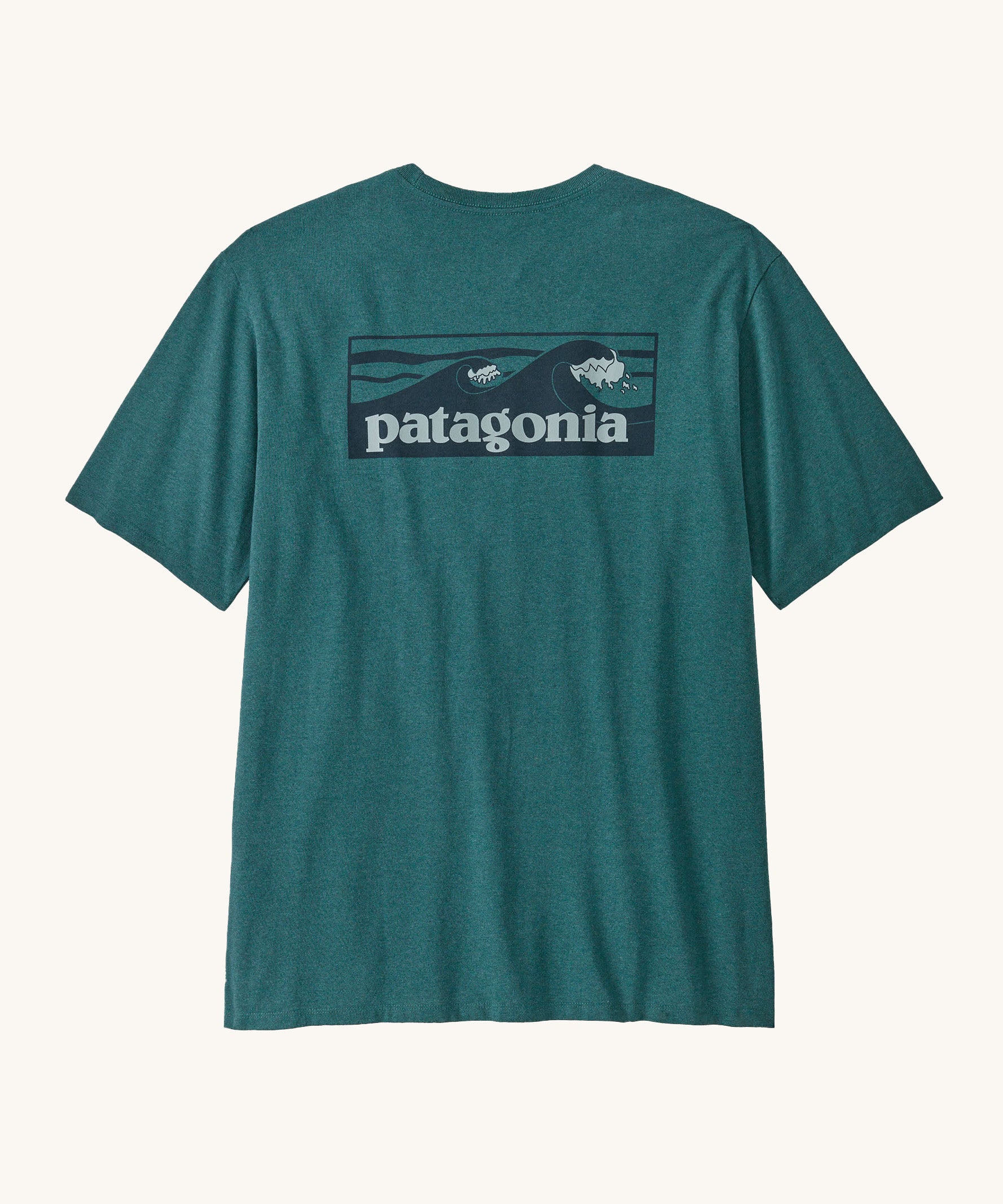 Patagonia mens turquoise short sleeve t-shirt wave design on a cream background.