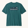 Patagonia mens turquoise short sleeve t-shirt wave design on a cream background.