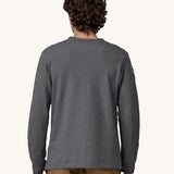 A view of the back of a man wearing a grey coloured Patagonia Men's Wildrise Crewneck Sweatshirt.