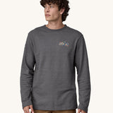 A man wearing a grey coloured Patagonia Men's Wildrise Crewneck Sweatshirt.