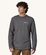A man wearing a grey coloured Patagonia Men's Wildrise Crewneck Sweatshirt.