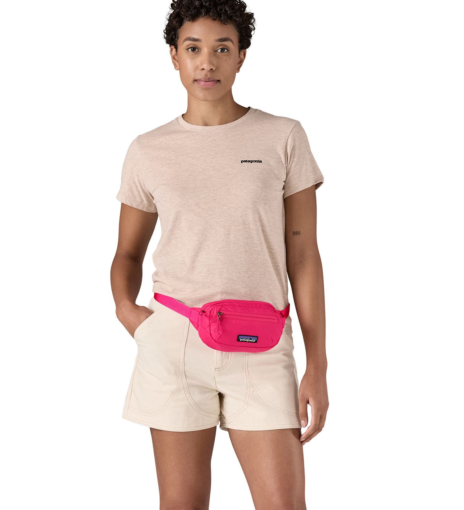 Patagonia Terravia Mini Hip Pack in a  luminous pink colour worn by an adult