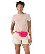 Patagonia Terravia Mini Hip Pack in a  luminous pink colour worn by an adult
