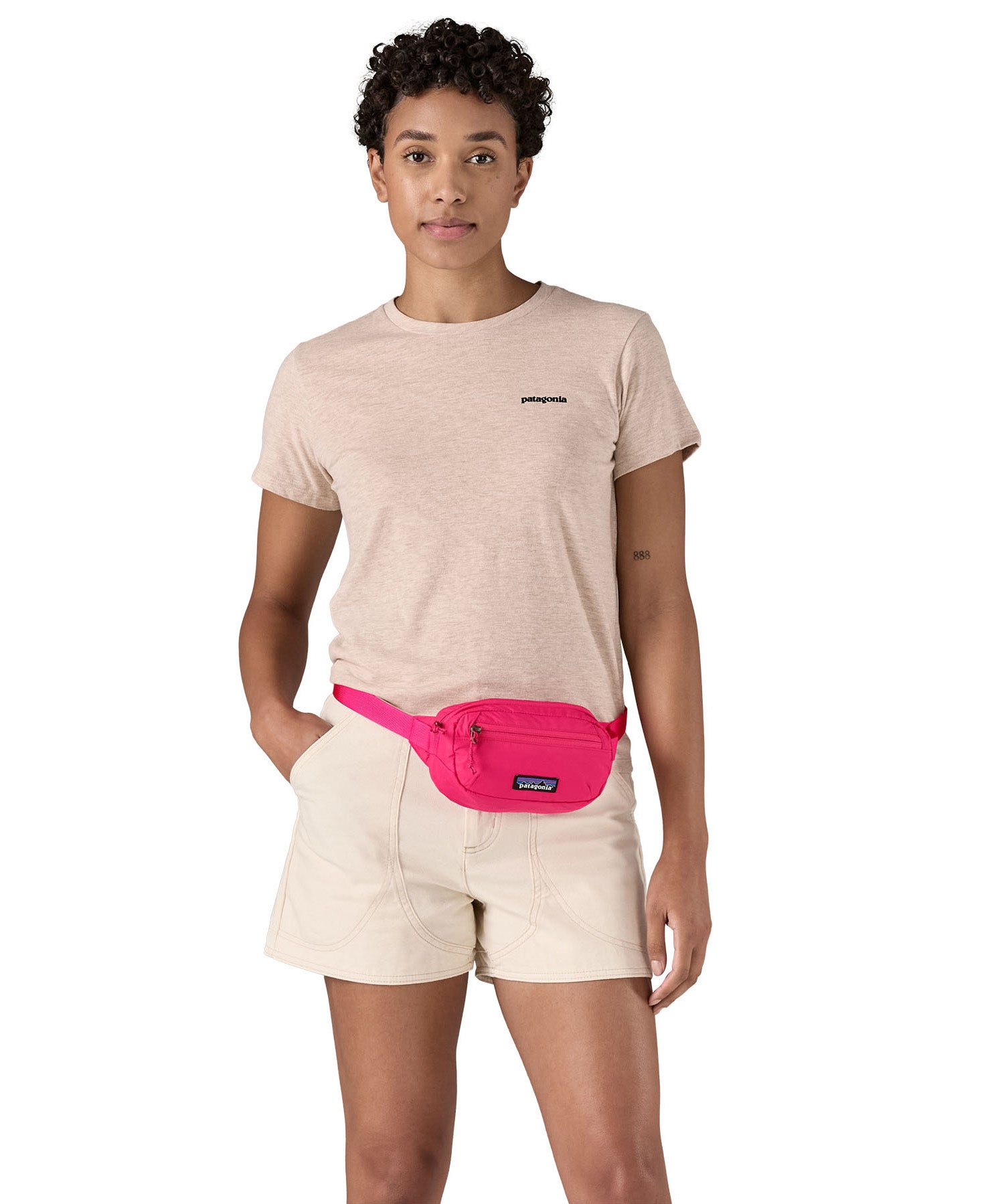 Patagonia Terravia Mini Hip Pack in a  luminous pink colour worn by an adult