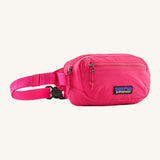Patagonia Terravia Mini Hip Pack in a  luminous pink colour on a cream background