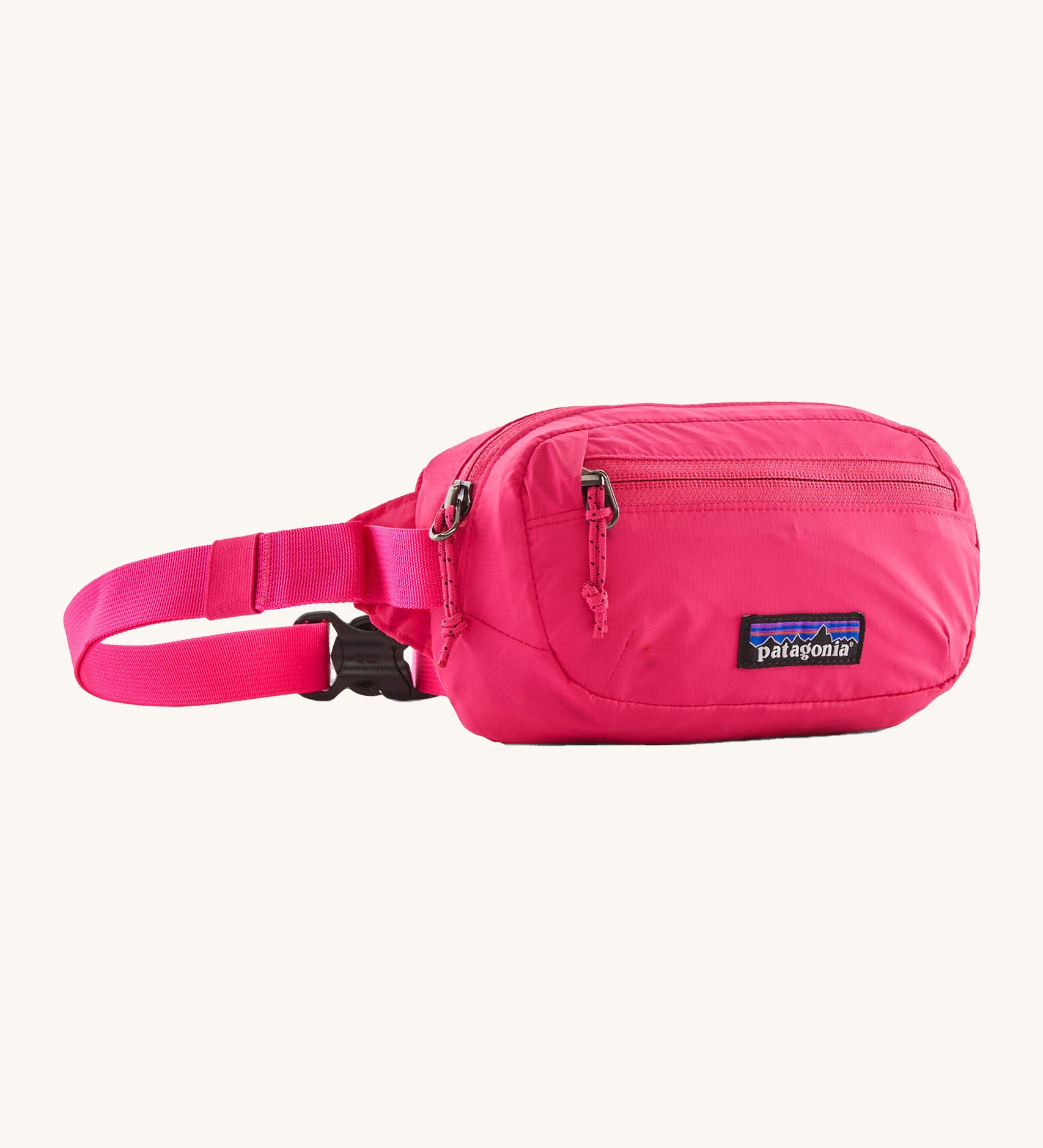 Patagonia Terravia Mini Hip Pack in a  luminous pink colour on a cream background