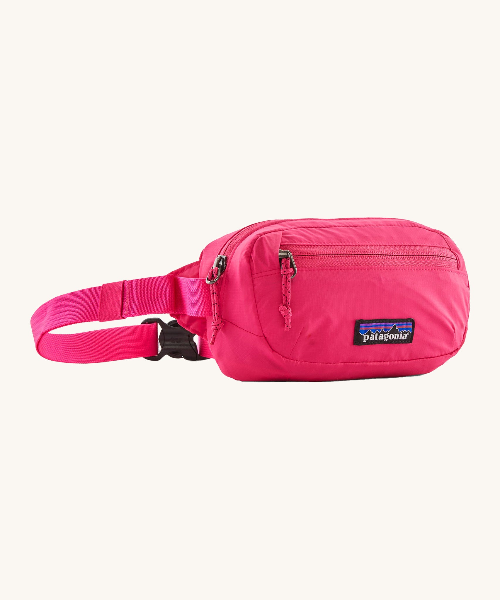 Patagonia Terravia Mini Hip Pack in a  luminous pink colour on a cream background