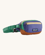 Patagonia Terravia Mini Hip Pack in a  solstice purple on a cream background.